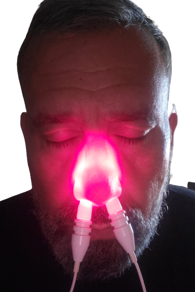 Man using the Nose Light Device with dual color probe red and infrared light therapy on his nose this sends light to the blood and plasma