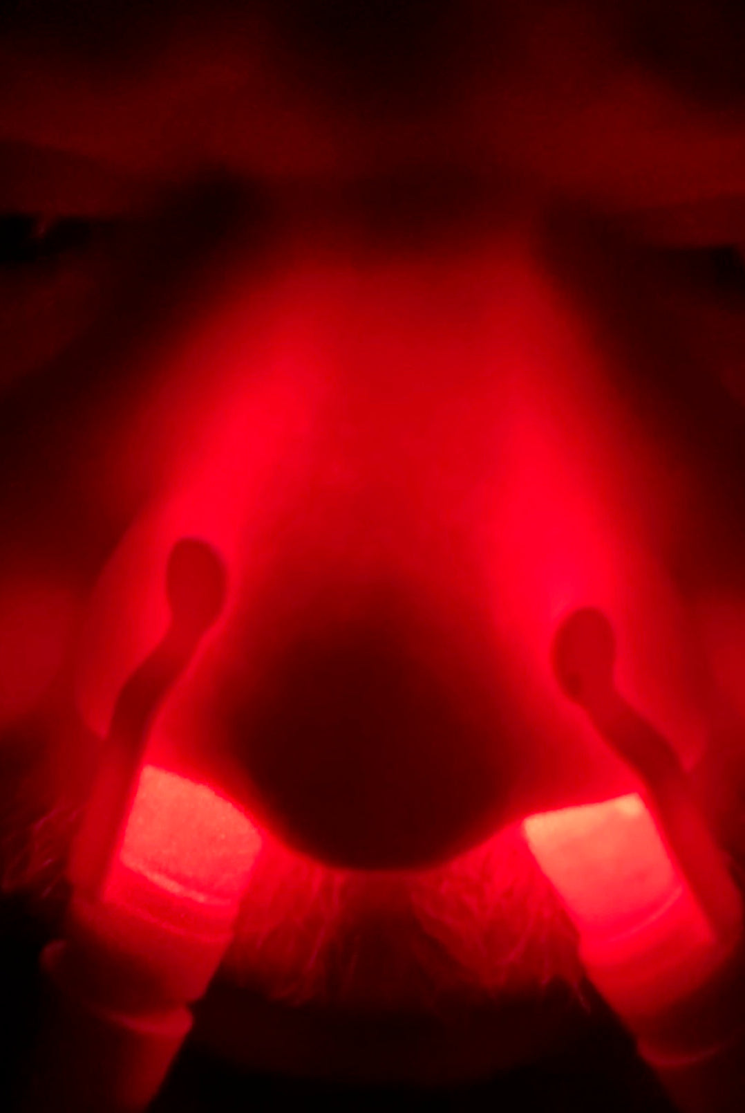 Individual applying red light therapy on his nose using the Nose Light Device